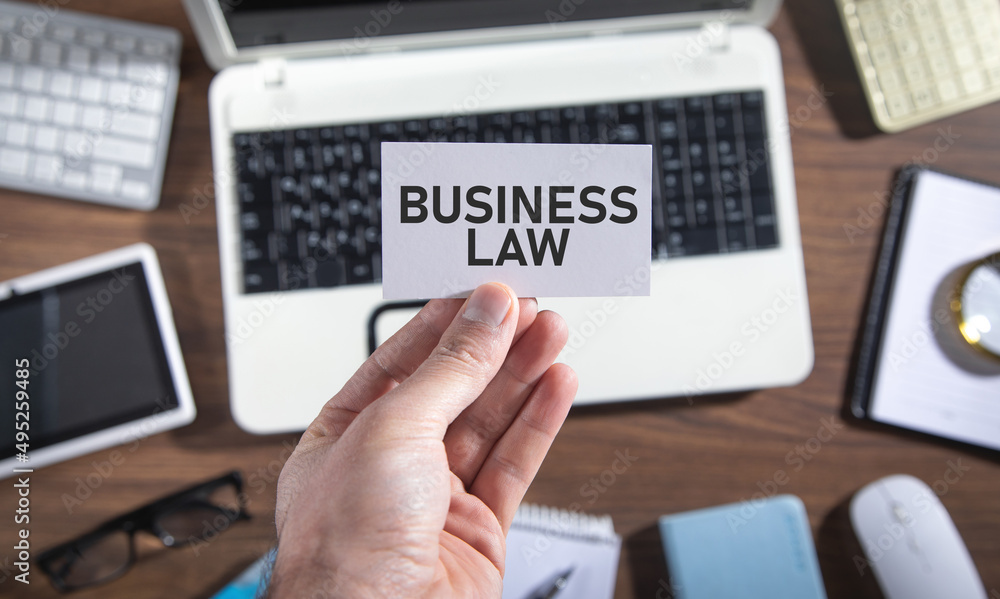 Male hand showing Business Law on business card. Male hand showing Business Law on business card.