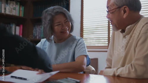 Wallpaper Mural Happy young Asian mature retirement couple signing agreement paper for the mortgage or life insurance and health insurance then making hand shaking with broker seller at home office. Torontodigital.ca