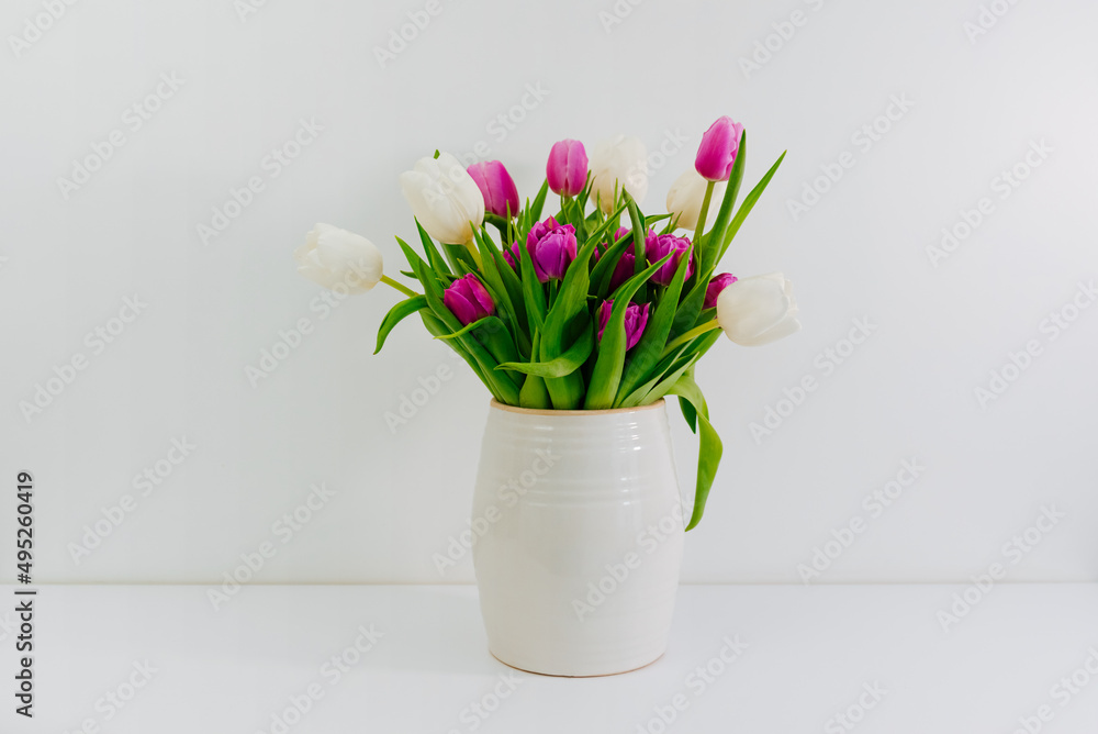 Bouquet of purple and white tulips on a white background