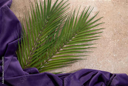 Palm Sunday background with green tropical tree leaves on stone photo