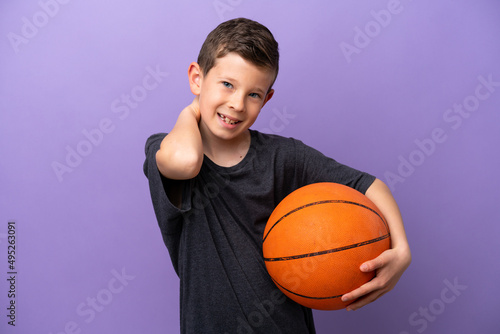 Little boy playing basketball isolated on purple background laughing