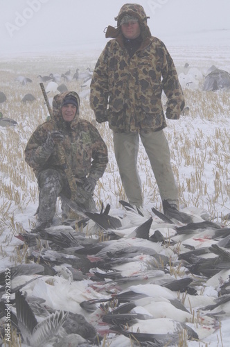 A pair of hunters and the morning's snow goose harvest photo