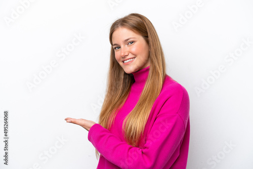 Young caucasian woman isolated on white background presenting an idea while looking smiling towards