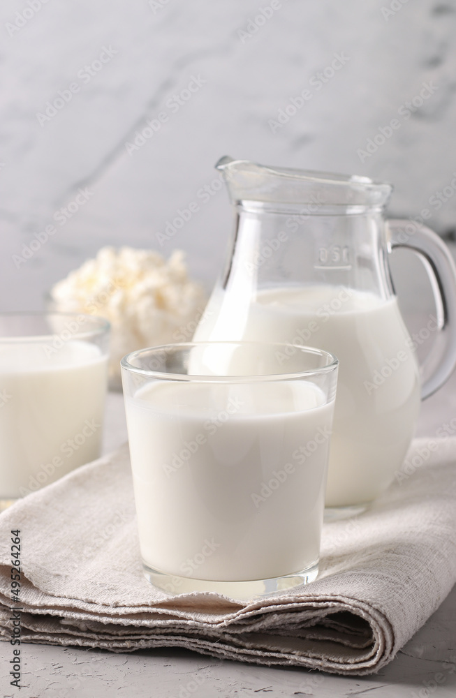 Fermented Drink Ayran in glass, milk in jug and curd in bowl on light gray background, Vertical format Fermented Drink Ayran in glass, milk in jug and curd in bowl on light gray background, Vertical format