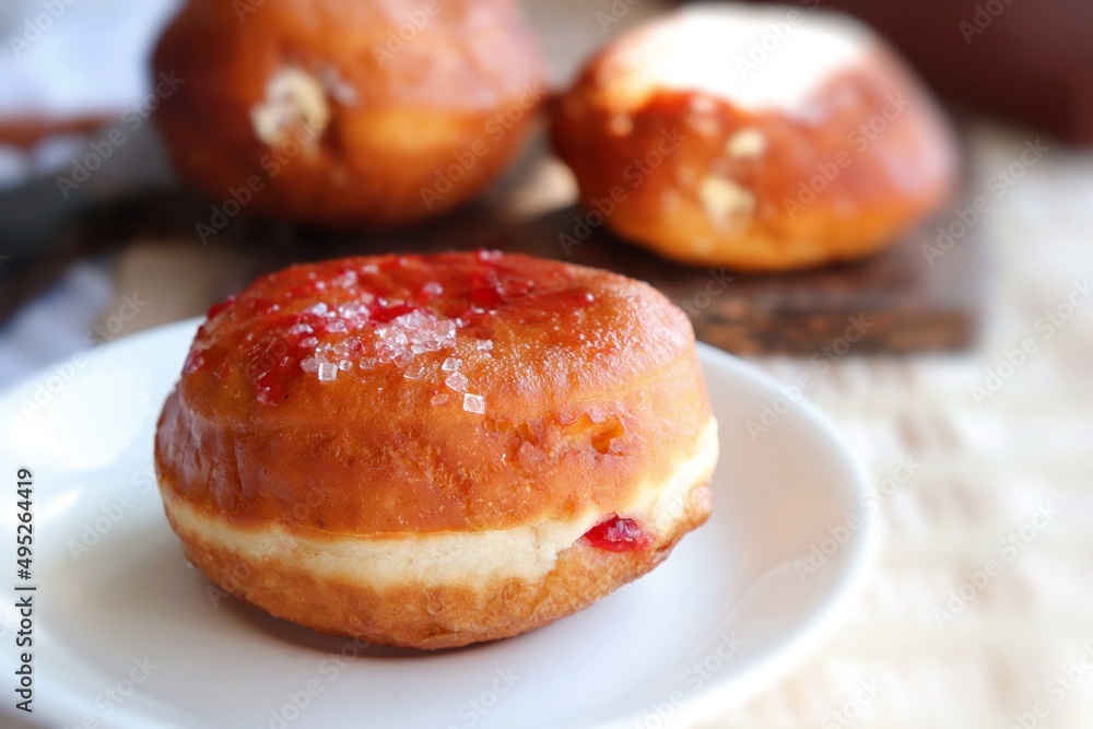 Cream filled jam donuts. garnished with sugar crystals. Traditional German Polish Donut with Raspberry Jam Dusted with Sugar. Cream filled jam donuts. garnished with sugar crystals. Traditional German Polish Donut with Raspberry Jam Dusted with Sugar.