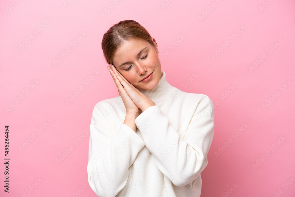 Young caucasian woman isolated on pink background making sleep gesture in dorable expression Young caucasian woman isolated on pink background making sleep gesture in dorable expression