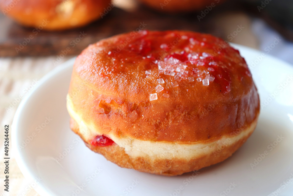 Cream filled jam donuts. garnished with sugar crystals. Traditional German Polish Donut with Raspberry Jam Dusted with Sugar. Cream filled jam donuts. garnished with sugar crystals. Traditional German Polish Donut with Raspberry Jam Dusted with Sugar.