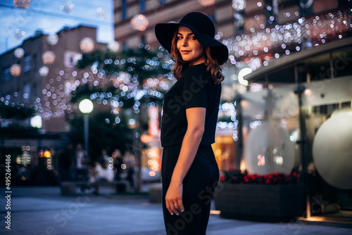 Beautiful fashionable woman in a hat and black clothing
