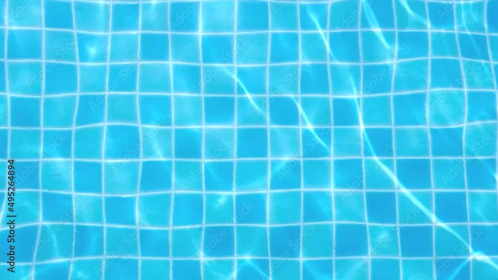 Blue tiled swimming pool with water wave ripples reflecting sunlight, background texture. Blue tiled swimming pool with water wave ripples reflecting sunlight, background texture.