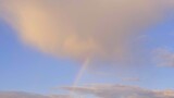 Multicolored rainbow and clouds in the sky after the rain, abstraction, blurred