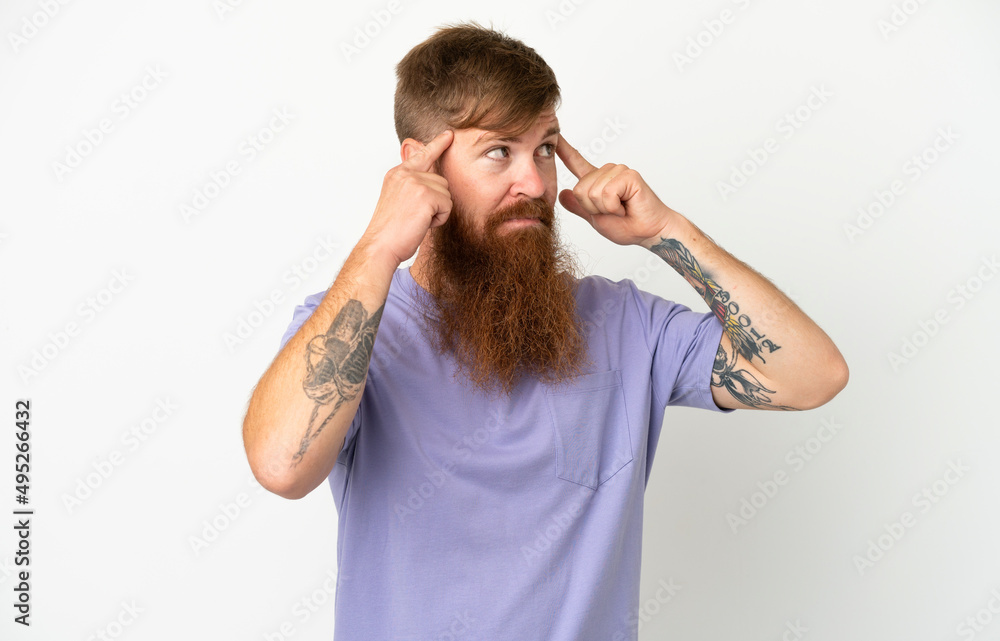 Young reddish caucasian man isolated on white background having doubts and thinking Young reddish caucasian man isolated on white background having doubts and thinking