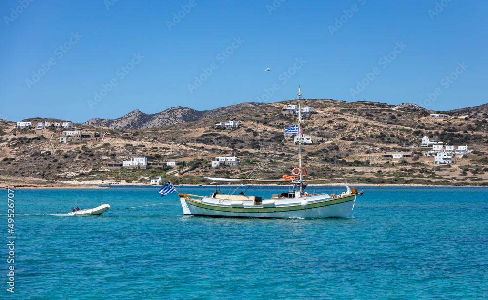 Fototapeta premium Fishing and inflatable boat moored in Aegean sea blue sky background. Paros Greek island, Cyclades