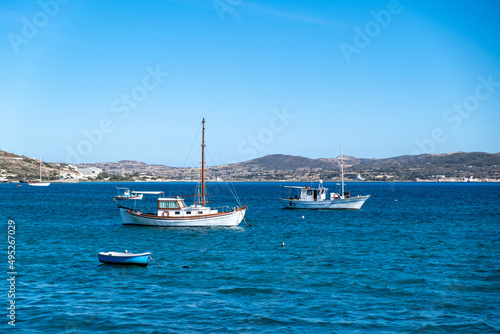 Milos Greek island  Cyclades. Fishing boat moored in open Aegean calm sea  blue sky background.