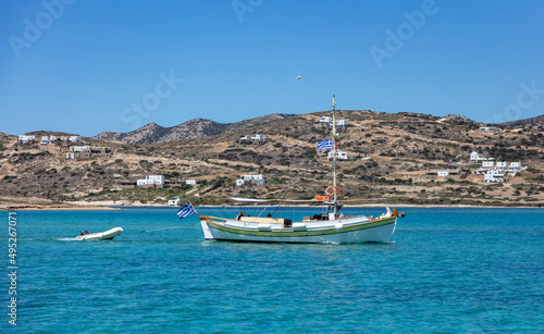 Fishing and inflatable boat moored in Aegean sea blue sky background. Paros Greek island, Cyclades