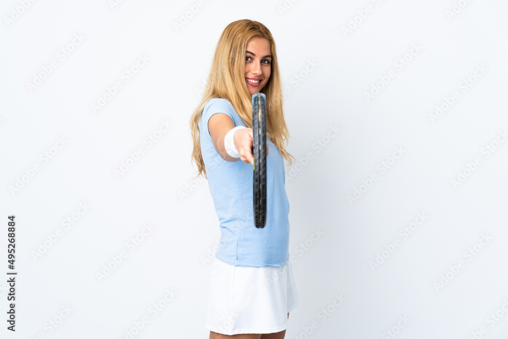 Young Uruguayan blonde woman over isolated white background playing tennis Young Uruguayan blonde woman over isolated white background playing tennis