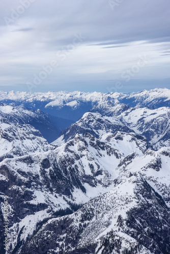 Aerial View of Canadian Rocky Mountain Landscape. Cloudy Sunset Sky. Located near Vancouver, British Columbia, Canada. Nature Background