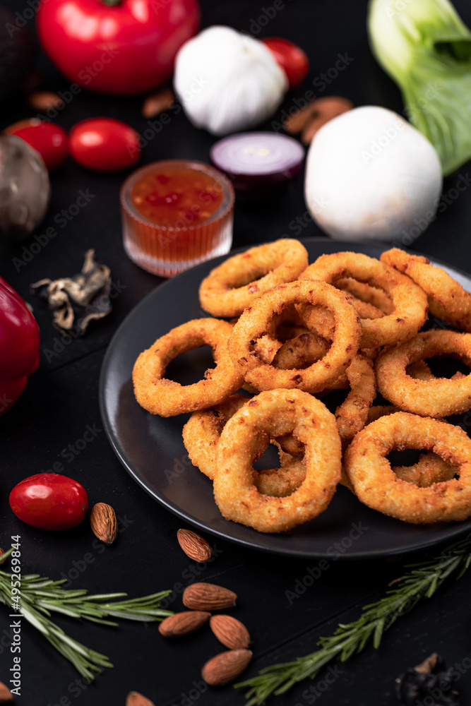 Naklejka premium Onion Ring into Sauce