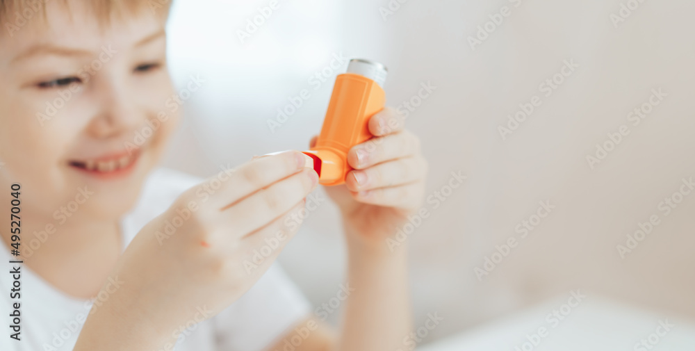 The little boy opened the lid and examines the inhaler. The little boy opened the lid and examines the inhaler.