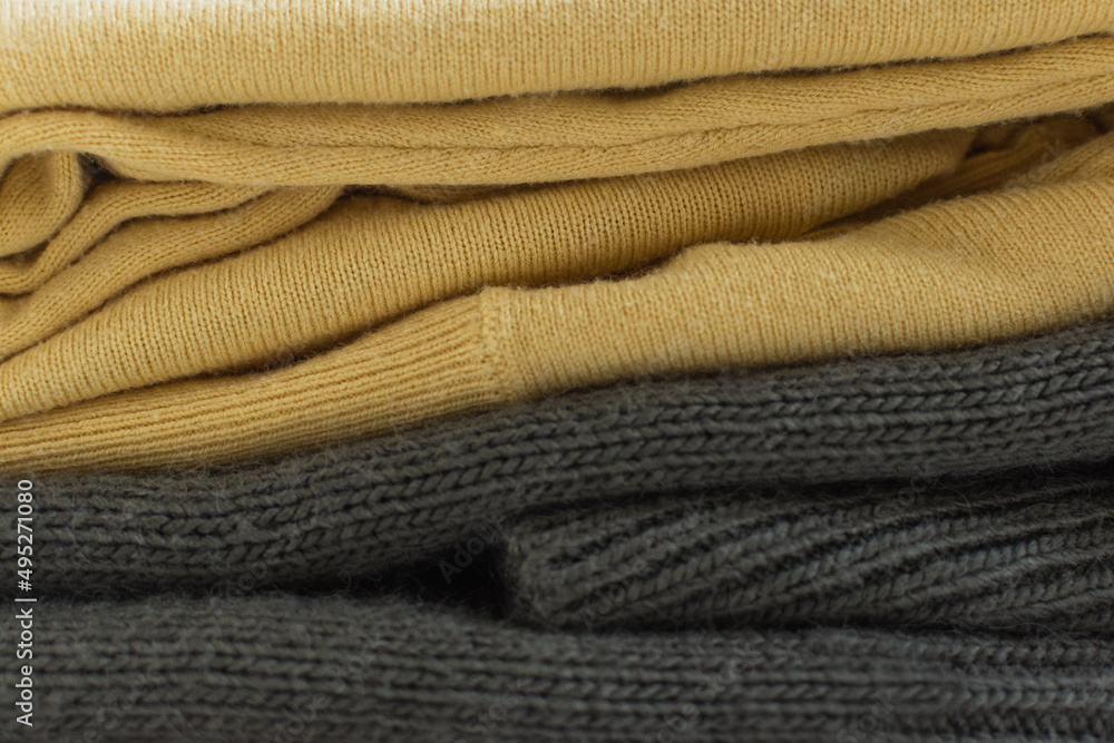 Two green and yellow knitted sweaters as background Two green and yellow knitted sweaters as background