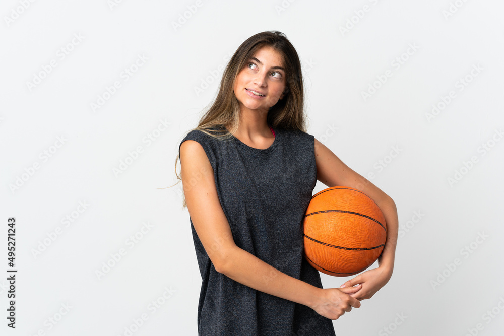 Young woman playing basketball isolated on white background thinking an idea while looking up