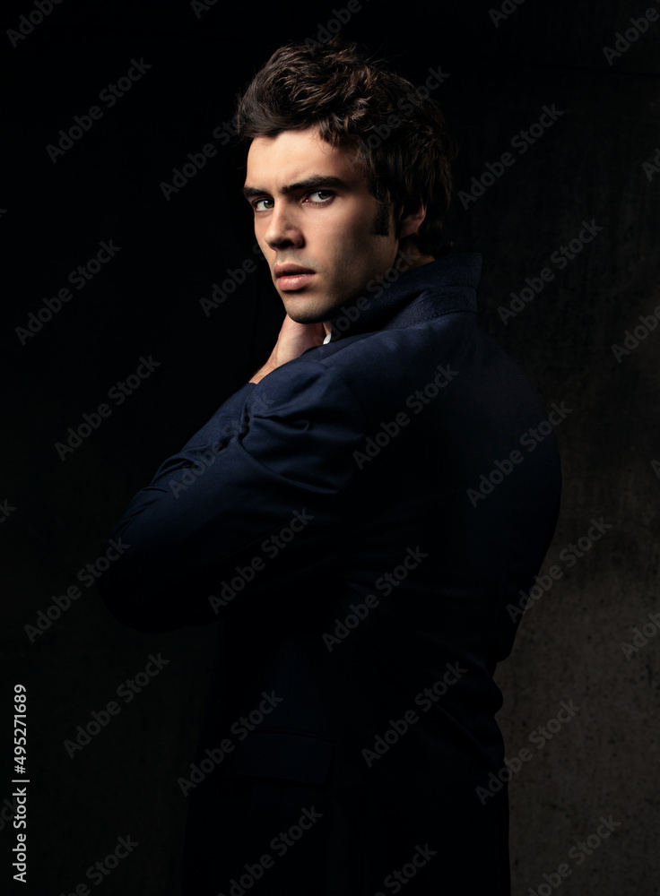 Charismatic handsome male in blue fashion suit and white style shirt sad looking down on dark shadow background. Closeup Charismatic handsome male in blue fashion suit and white style shirt sad looking down on dark shadow background. Closeup