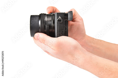 Mirrorless camera in the hands of a photographer on a white background