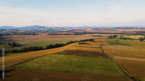 Ukrainian fields stretch on the hills near the settlements Aerial view