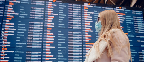 Banner caucasian young woman in protective mask background information board in airport terminal for plane