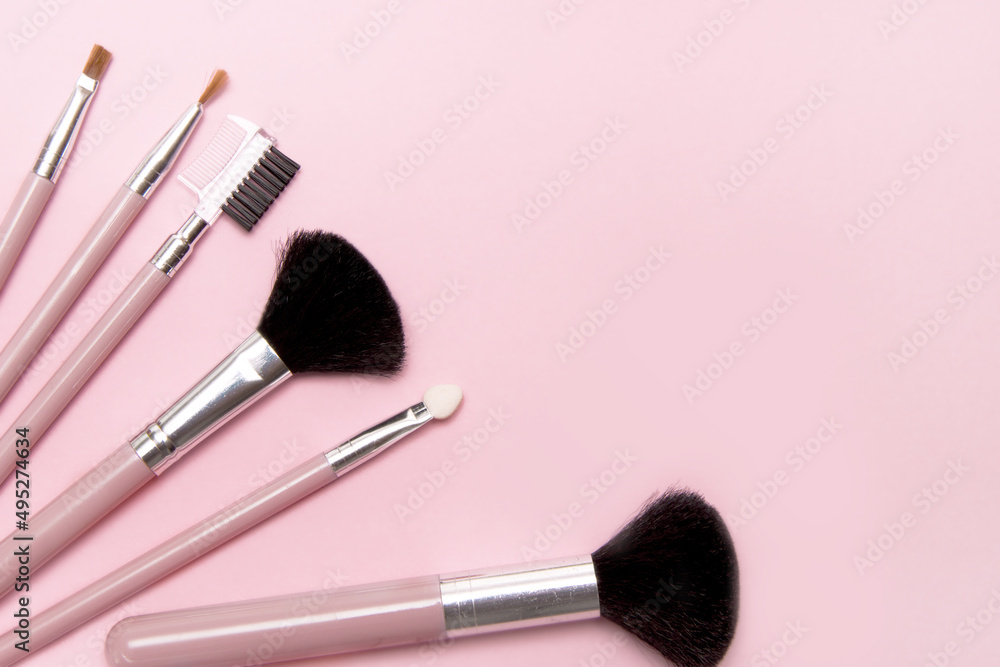 makeup brushes on pink background with place for text and advertising makeup brushes on pink background with place for text and advertising