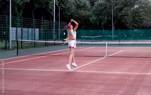 girl playing tennis in the city tennis court © Антонина Лунева
