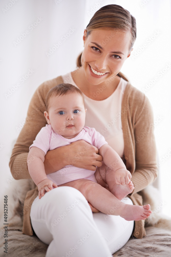 Shes such a proud mom. Shot of a young mother bonding with her baby girl.