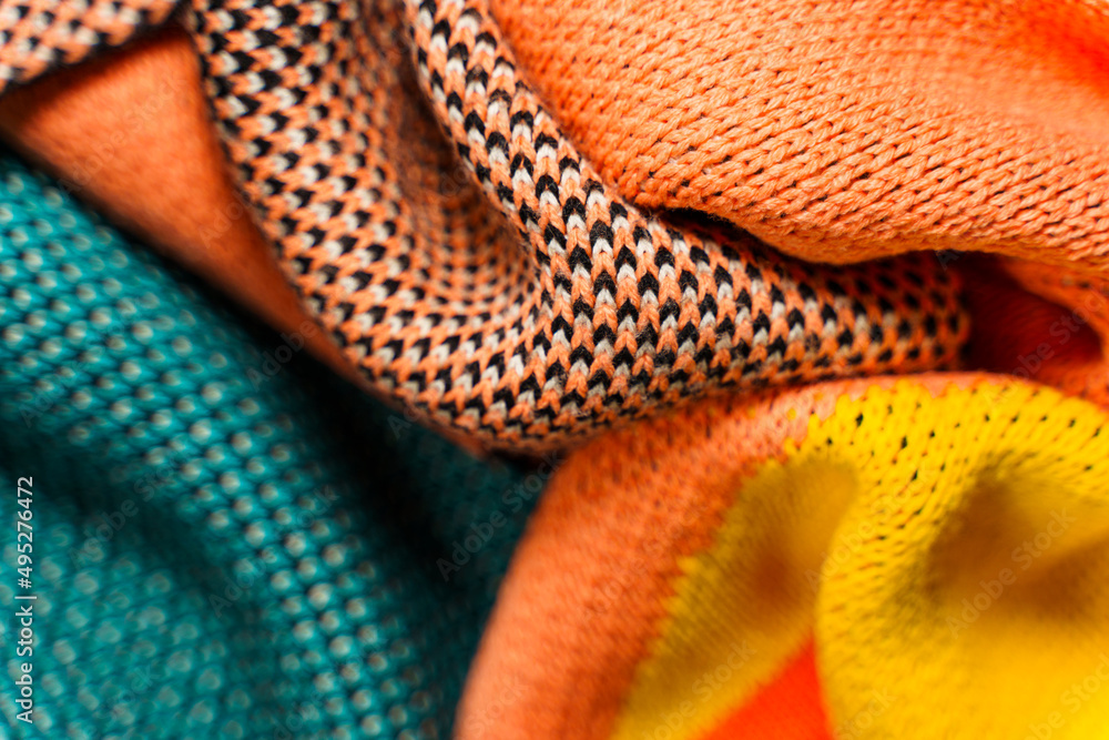 A pile of multi-colored knitted fabrics A pile of multi-colored knitted fabrics