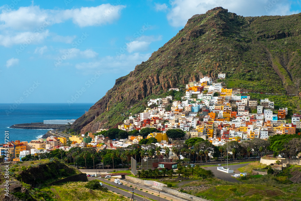 colorful seaside village in the foothills of the mountain. Tenerife. Canary Islands.