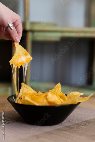 Nachos with melted stringy cheese.