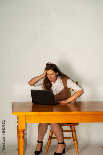 Pretty businesswoman working at her computer in her home office.