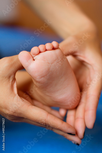 The woman tenderly embraced the baby's legs