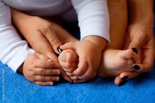 The woman tenderly embraced the baby's legs