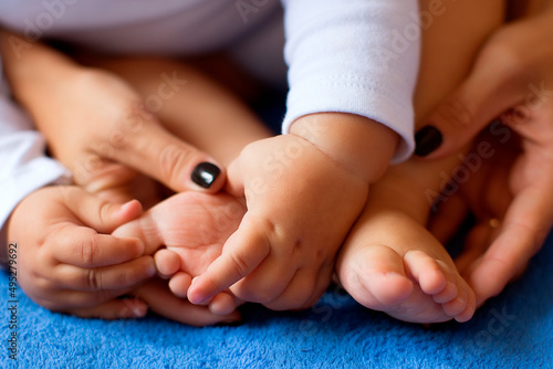 The woman tenderly embraced the baby's legs