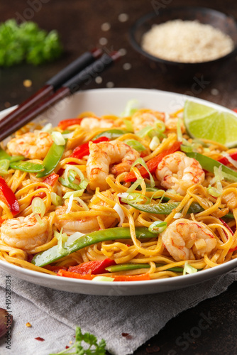 Stir fry noodles with prawns and vegetables in white plate. Healthy asian food © grinchh