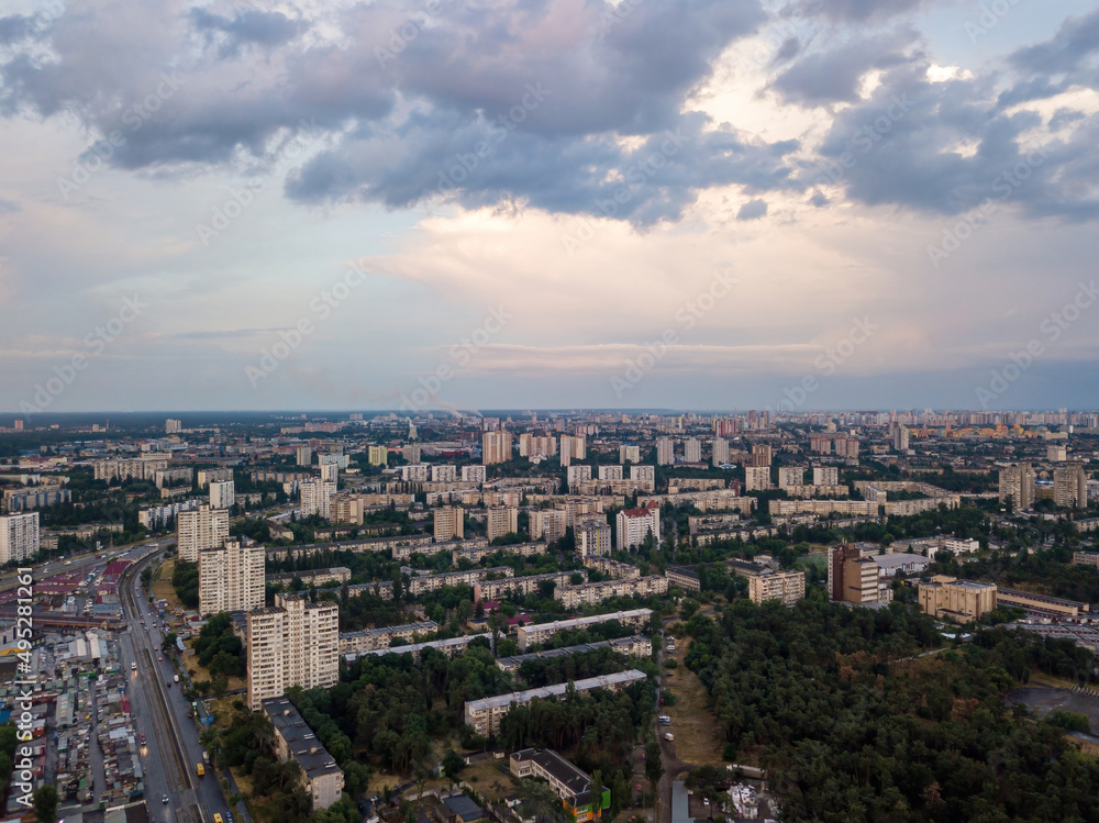 Sunset over Kiev. Rain clouds in the sky. Aerial drone view.