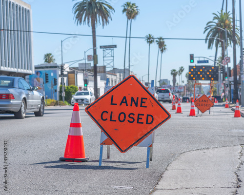 A lane closed sign is posted on Sunset Boulevard to help commuters navigate a busy construction area.
