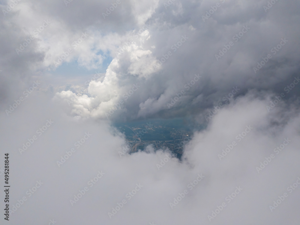 Naklejka premium High flying in the clouds. Aerial drone view.