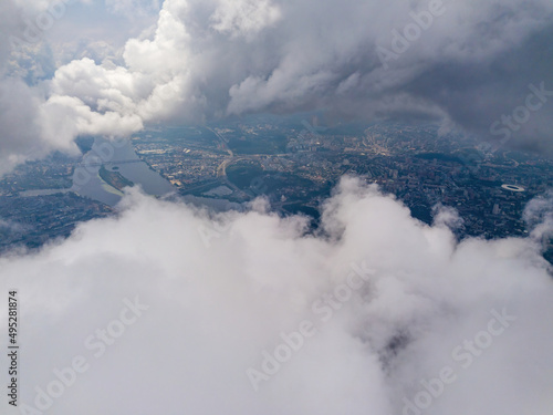 Kyiv city through high clouds. Cloudy day. Aerial drone view.