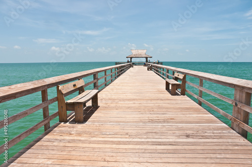 front view of a deserted  wood pier  extending one hundred yards  into the gulf of Mexico  on a sunny afternoon