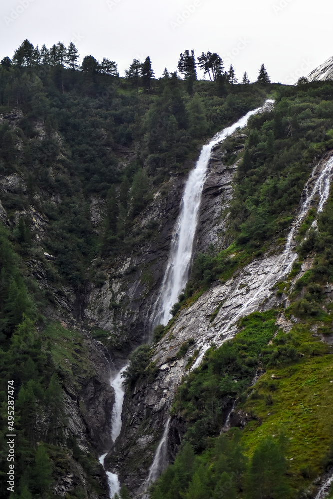 Beautiful waterfall in the mountains (alps). Scenic valley in Kärnten, Austria.