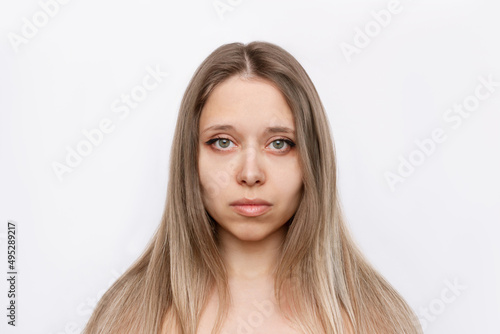 Portrait of a young attractive caucasian blonde woman with long hair isolated on a white background.. Natural beauty and fashion. Skin care