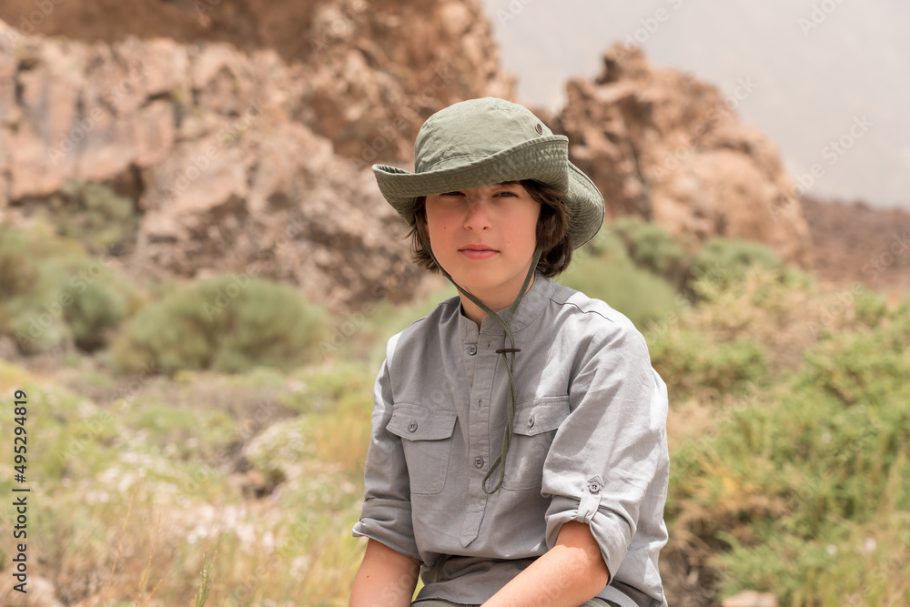 Portrait of a teenager on the background of rocks.