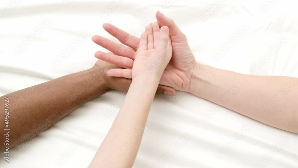 Hands close up multiracial family love african man, caucasian woman and child touch each other on white. Hands close up multiracial family love african man, caucasian woman and child touch each other on white.