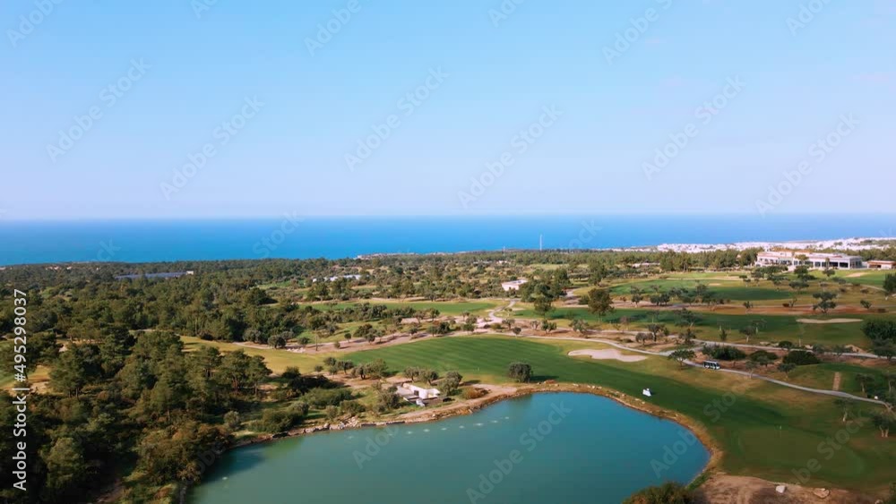 Aerial view of Golf Course with putting green grass and trees on golf field Fairway and putting green top view Amazing bird eye view over Golf courses in summer sunny day in Cyprus Aerial view of Golf Course with putting green grass and trees on golf field Fairway and putting green top view Amazing bird eye view over Golf courses in summer sunny day in Cyprus