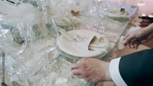Waiter arrange table before celebration in the restaurant